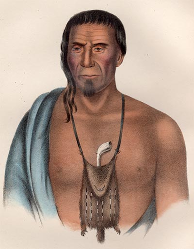 portrait from waist up, of a man of muscular frame, about 45 to 50 years old. An animal-pelt bag holding a pipe hangs from his neck.